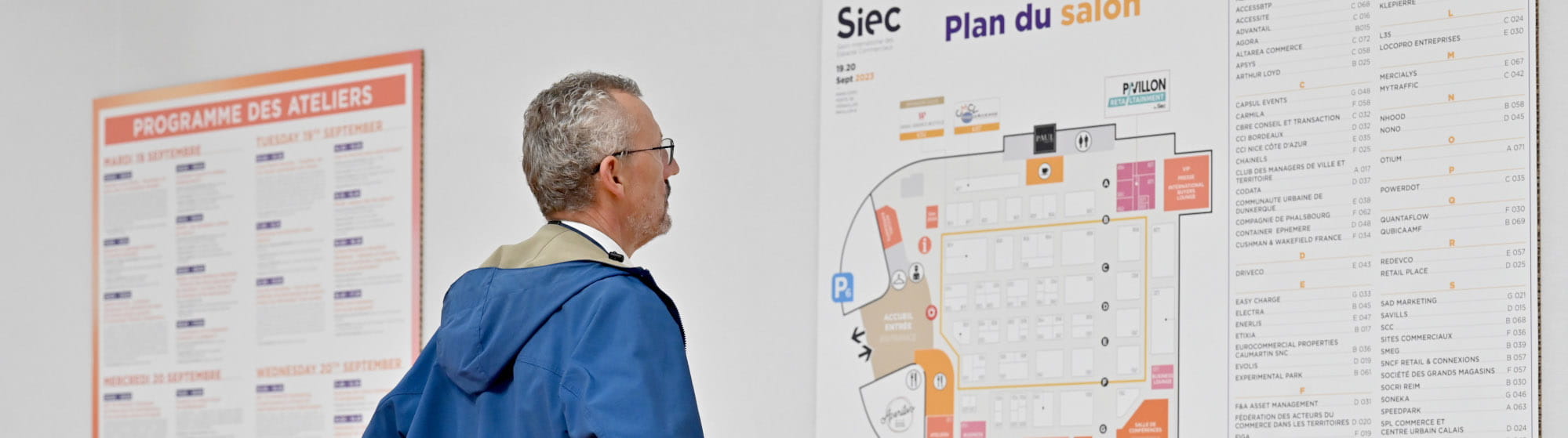 Visitor looking at the floor plan of the Siec event